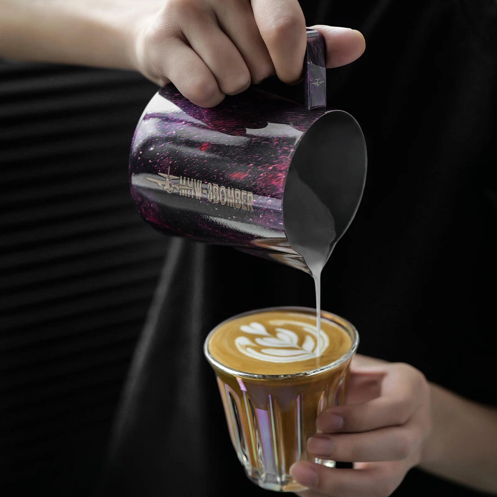 MHW-3BOMBER purple latte art pitcher pouring milk into coffee; features unique crocodile spout. 