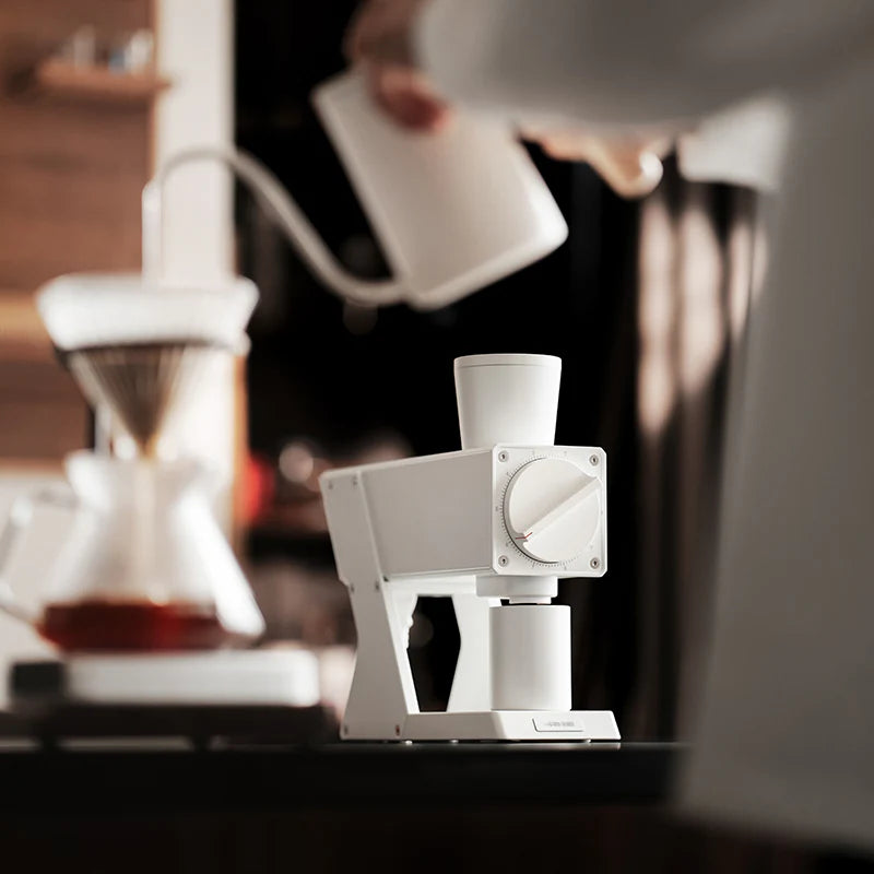 MHW-3BOMBER white F74 electric coffee grinder being used. Modern design, stepless adjustment.