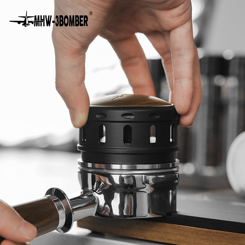 MHW-3BOMBER Falcon coffee distributor in use. Black with wood top. Gravity adaptive espresso tool.