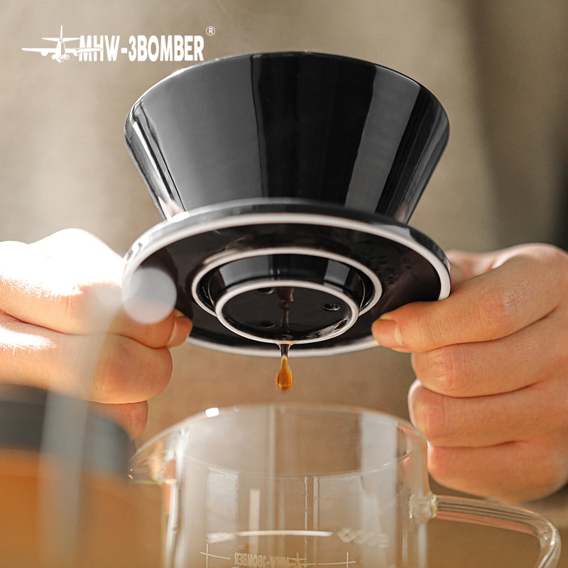 MHW-3BOMBER black ceramic Meteor coffee dripper in use. Brewing coffee into glass server. 