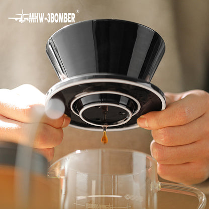 MHW-3BOMBER black ceramic Meteor coffee dripper in use. Brewing coffee into glass server. 