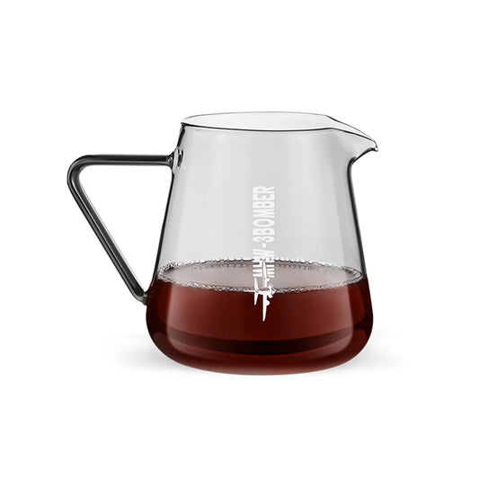 The MHW-3BOMBER Elf Coffee Server, crafted from borosilicate glass with a black handle, is partially filled with coffee. It offers a drip-free pour design and displays white text with a small airplane graphic on its side.