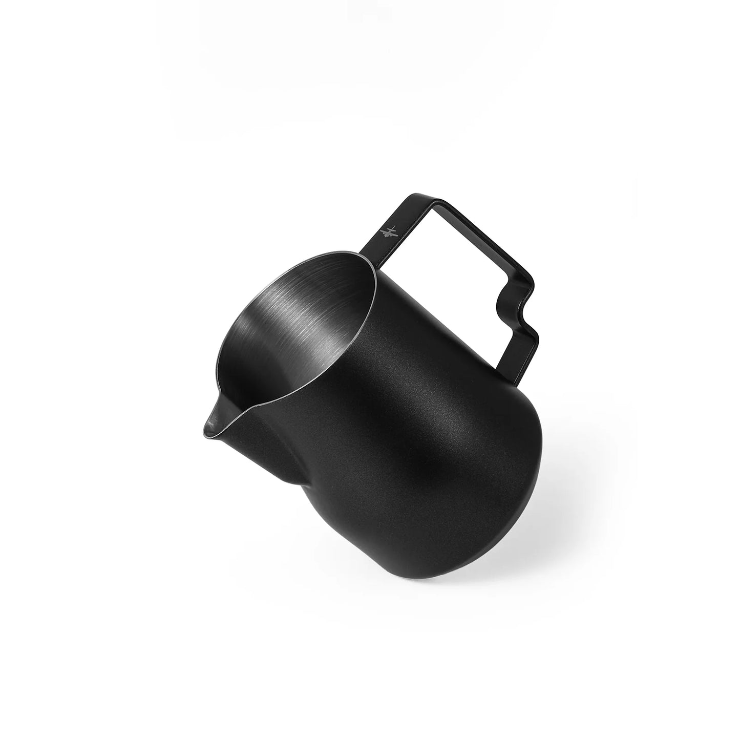 The MHW-3BOMBER Turbo Milk Pitcher Matte Black is a matte black stainless steel pitcher with a smooth finish, ideal for latte art. It features an angular handle and is displayed at an angle against a white background.