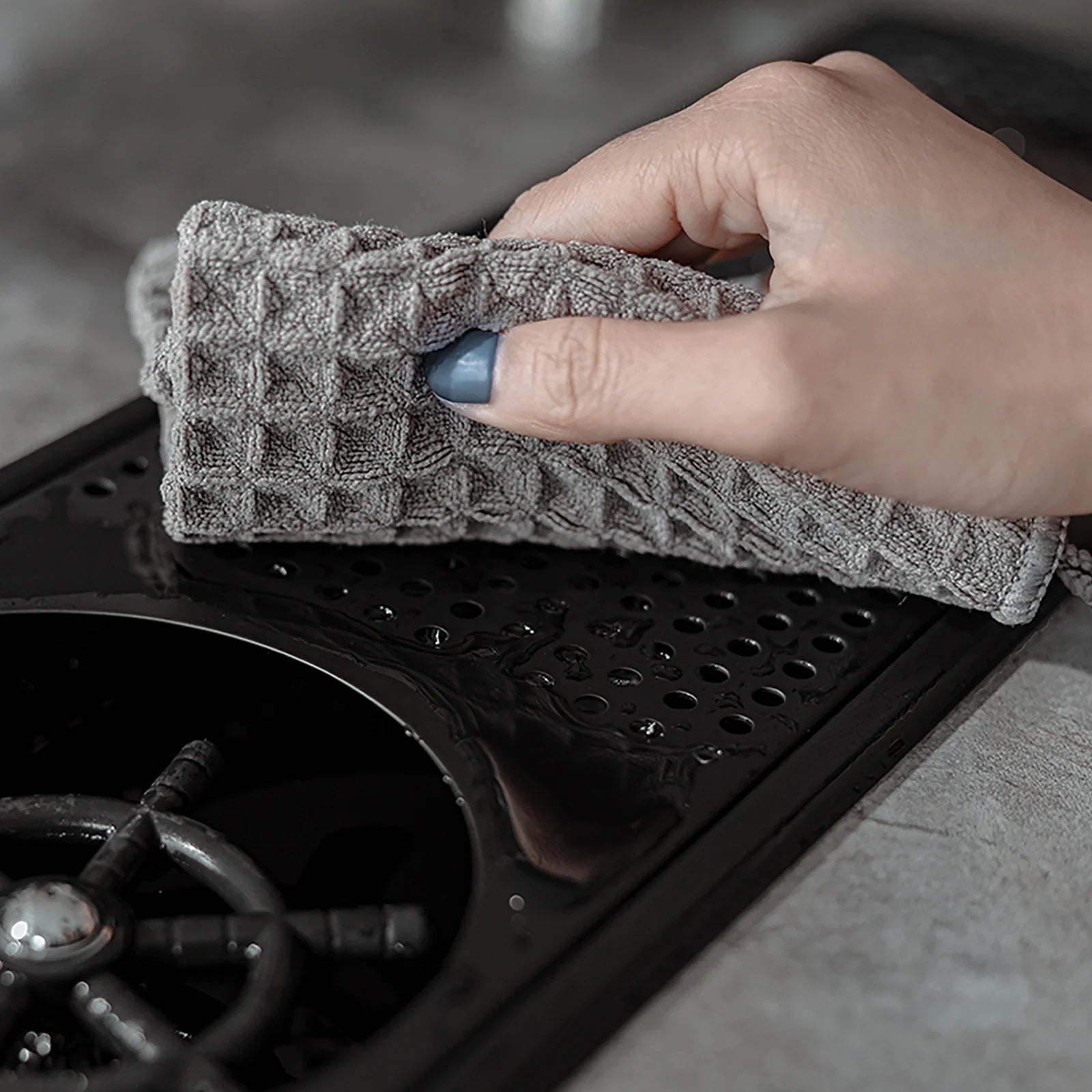 MHW-3BOMBER dark grey waffle towel cleaning a glass rinser. Soft, absorbent microfiber cloth. 