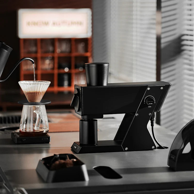 MHW-3BOMBER F74 Navigator coffee grinder. Black, stepless adjustment, and vertical chute design on counter. 