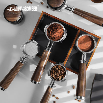 The top view highlights MHW-3BOMBER Bottomless Portafilters with natural walnut handles on a gray surface—one filled with ground coffee, one with beans, and another empty. Shadows pattern beside the stainless steel portafilters. The MHW-3BOMBER logo is at the top left corner.