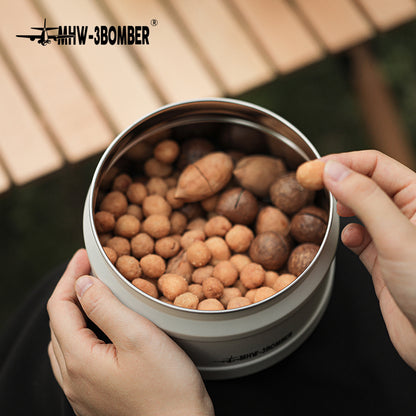 MHW-3BOMBER vacuum canister filled with coffee beans, being held.