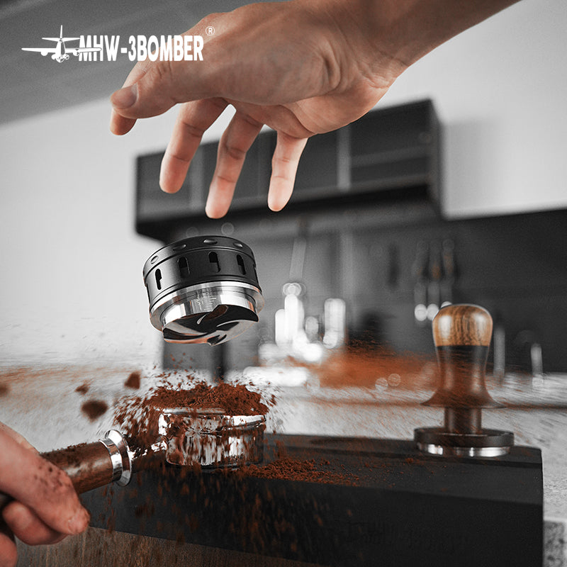 MHW-3BOMBER Falcon coffee distributor in use. Black and silver espresso leveler tool. Gravity adaptive system.