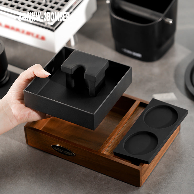 MHW-3BOMBER espresso tamping station. Wood tray with black portafilter holder and tamping mat. 