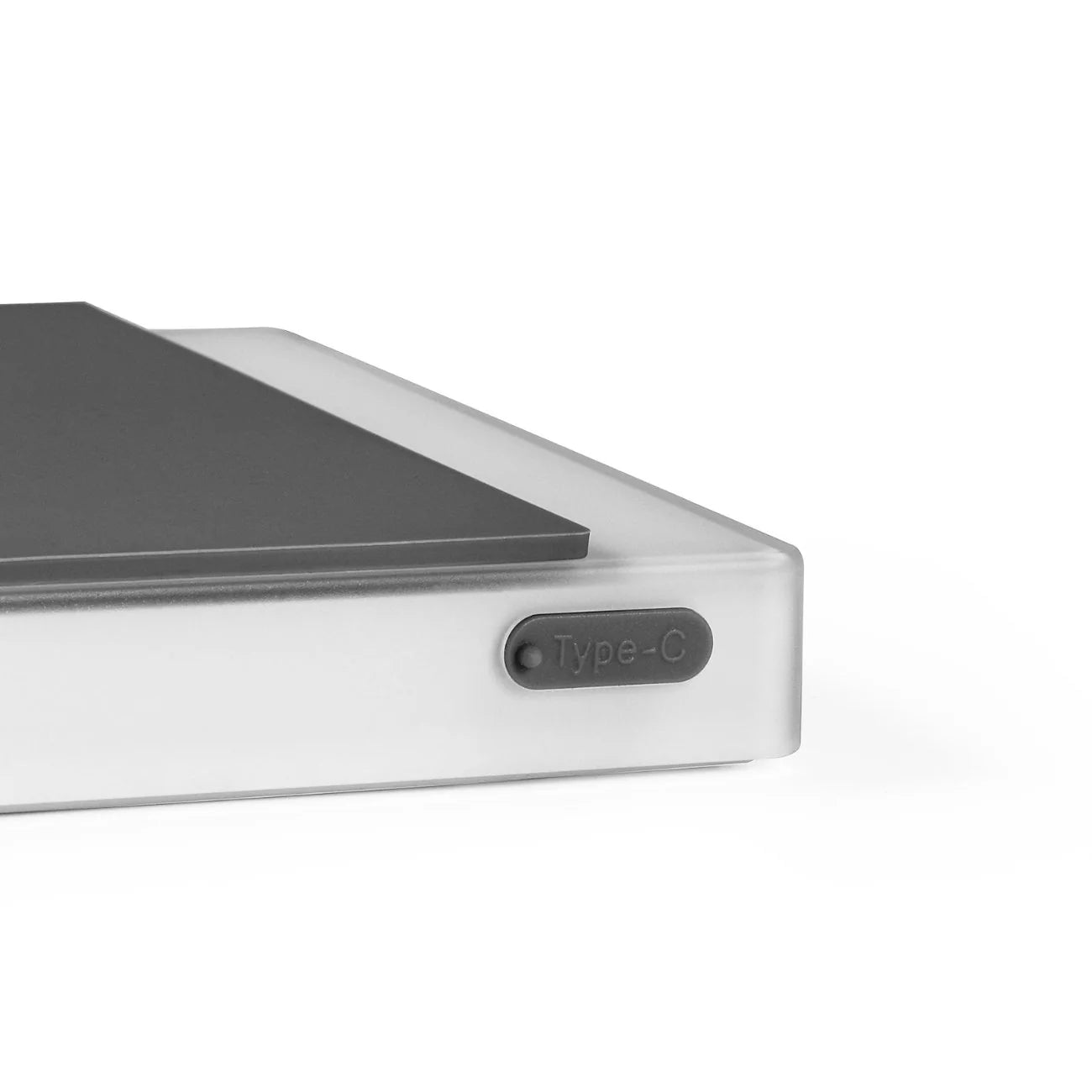 The MHW-3BOMBER Espresso Scale Cube Coffee Scale 2.0 showcases a sleek, modern corner with a translucent casing and a marked Type-C port, indicating USB rechargeability. Its minimalist design embodies the precision typical of premium gadgets.