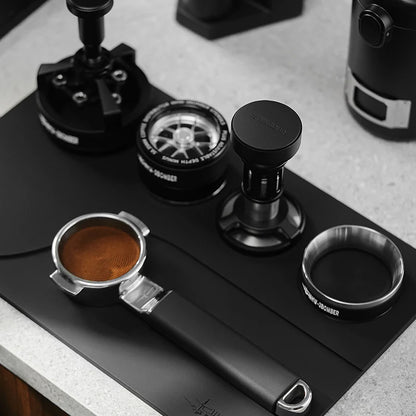 MHW-3BOMBER black silicone tamping base with portafilter, tamper, distributor and dosing funnel slots.