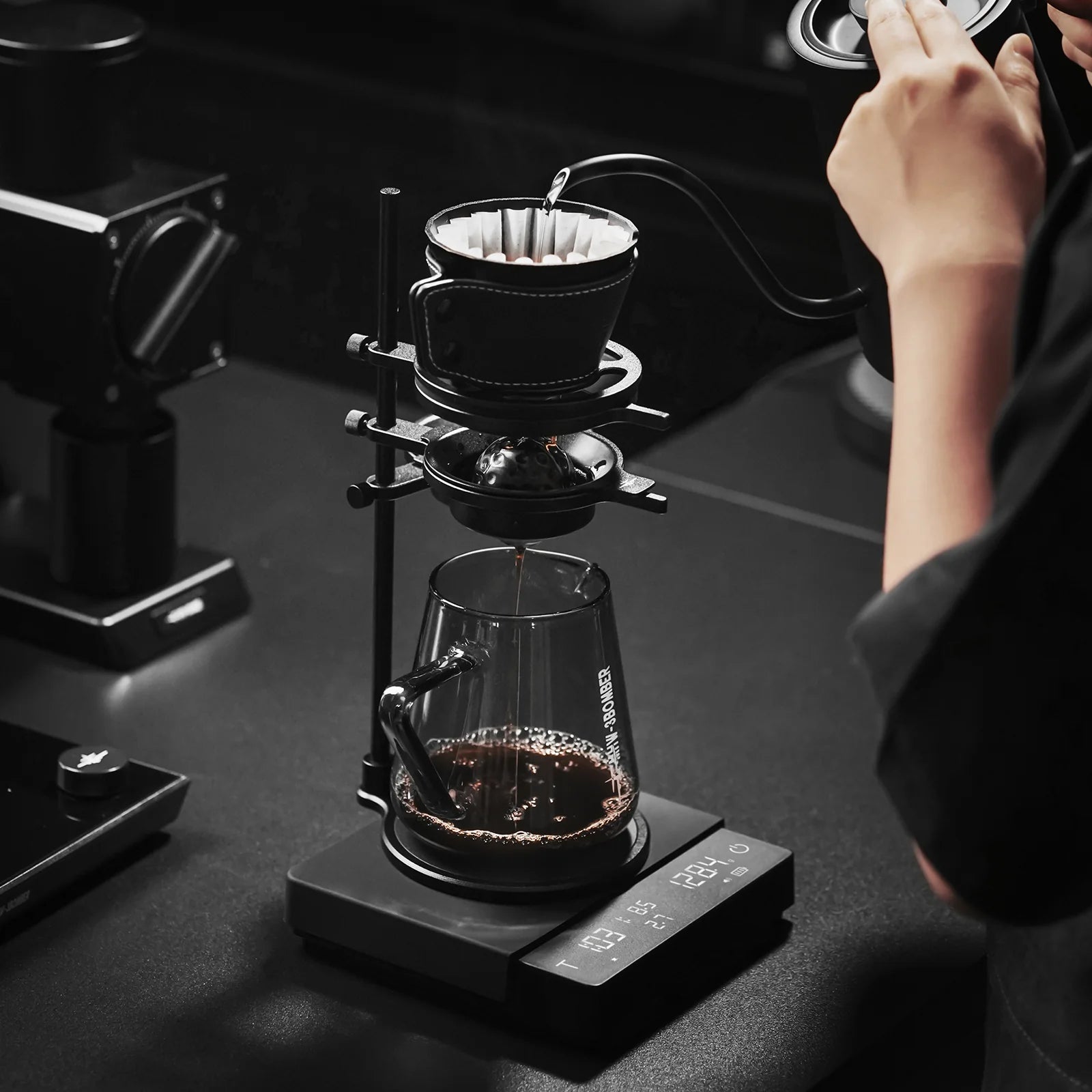 MHW-3BOMBER Cube Coffee Scale 3.0 Pro Max in use. Black scale with pour-over setup on top. 