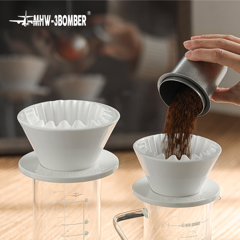MHW-3BOMBER Meteor Coffee Dripper (white). Coffee grounds being poured in. 1-2 person capacity.