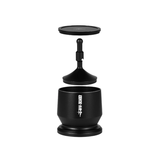 The exploded view of the MHW-3BOMBER Espresso Coffee Powder Dosing Funnel displays its components—base with logo, central stem, and circular top with cross lines—perfect for home enthusiasts and baristas. These parts are meticulously aligned vertically against a pristine white background.