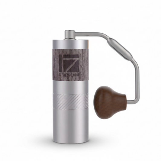 Silver manual coffee grinder with wooden handle on a white background