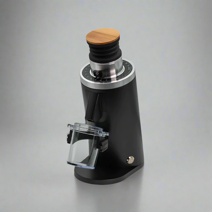 The DF54 - 54mm Flat Burr Coffee Grinder by Fix Coffee is sleek and modern, featuring a black cylindrical body with a wooden top and transparent container. Its tailored for home baristas seeking precision, with a control dial near the top, embodying elegance against any backdrop.