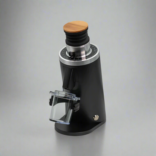 The DF54 - 54mm Flat Burr Coffee Grinder by Fix Coffee is sleek and modern, featuring a black cylindrical body with a wooden top and transparent container. Its tailored for home baristas seeking precision, with a control dial near the top, embodying elegance against any backdrop.
