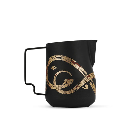 The MHW-3BOMBER Turbo Milk Pitcher-Year of the Snake Limited Edition, a black austenitic 304 stainless steel frothing pitcher, showcases a striking gold snake design with a spout and black handle that contrasts beautifully against the white background.
