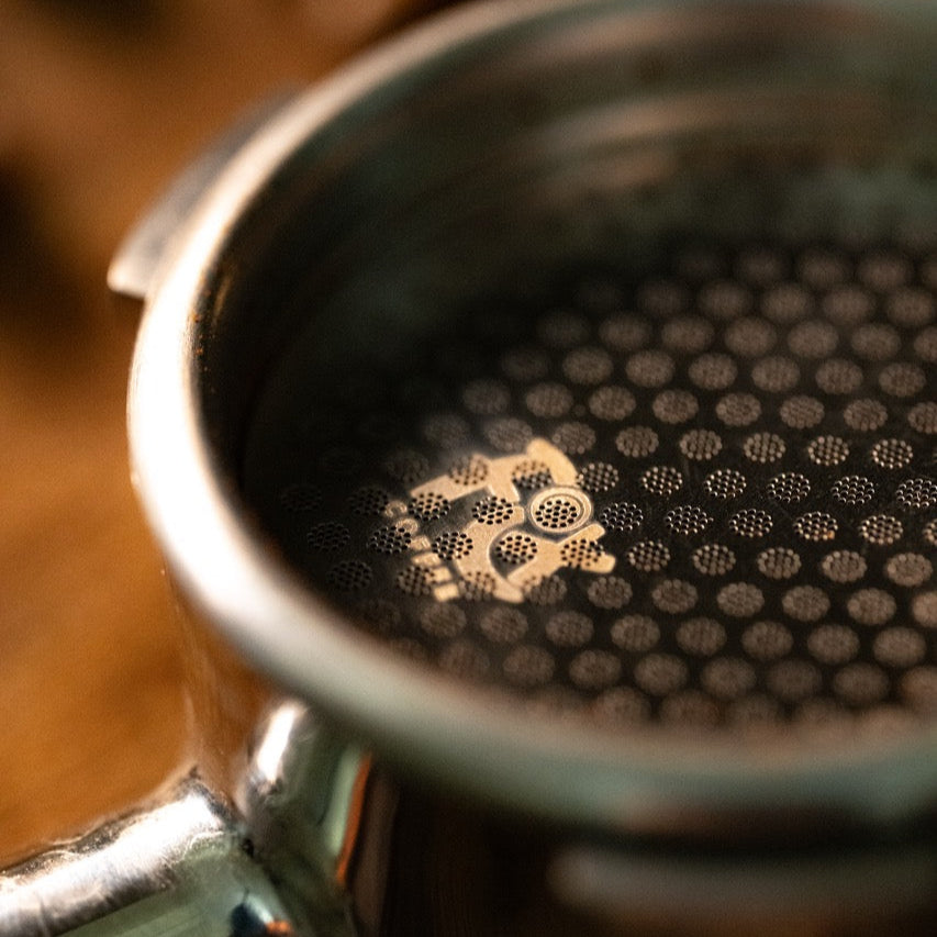 Close-up of a FIX COFFEE titanium plated espresso puck screen, showing its fine mesh and circular pattern.