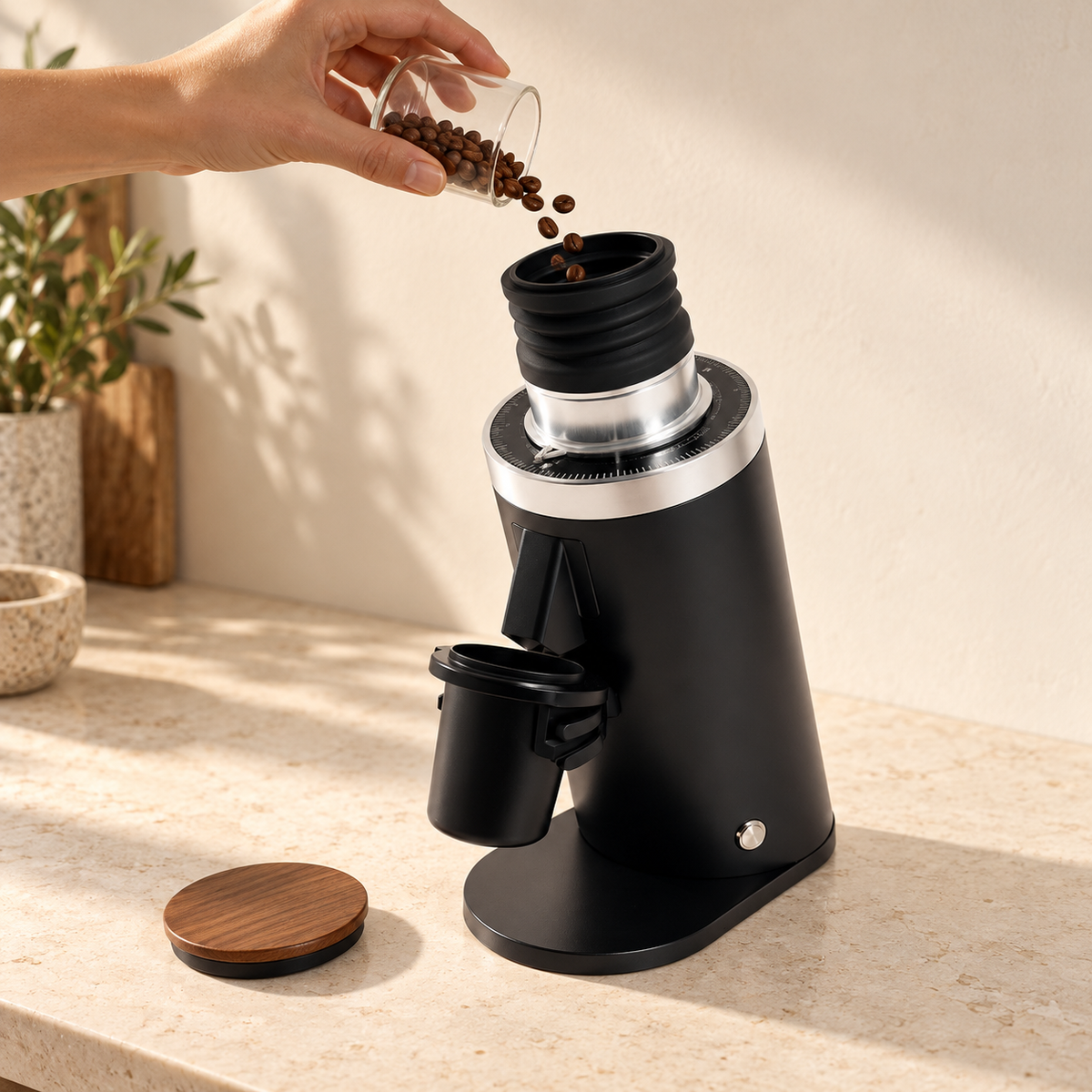 A hand pours a single dose of beans into the open DF64 bellows hopper (reference render)