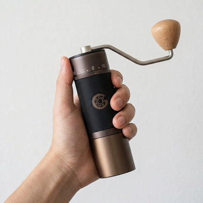 Hand holding KINGrinder K7 grinder showing compact portable size