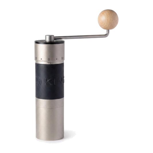 KINGrinder K6 hand grinder in silver, upright with the crank arm extended and its wooden knob, on a white background