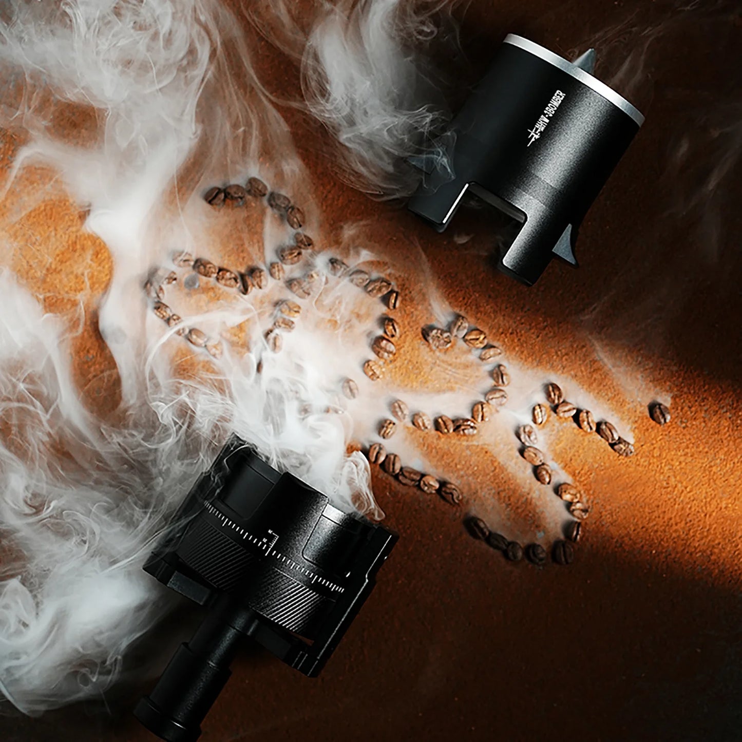 MHW-3BOMBER SE Pro espresso shaker funnel. Black, conical design. Grounds dosing for espresso on table with coffee beans and smoke.