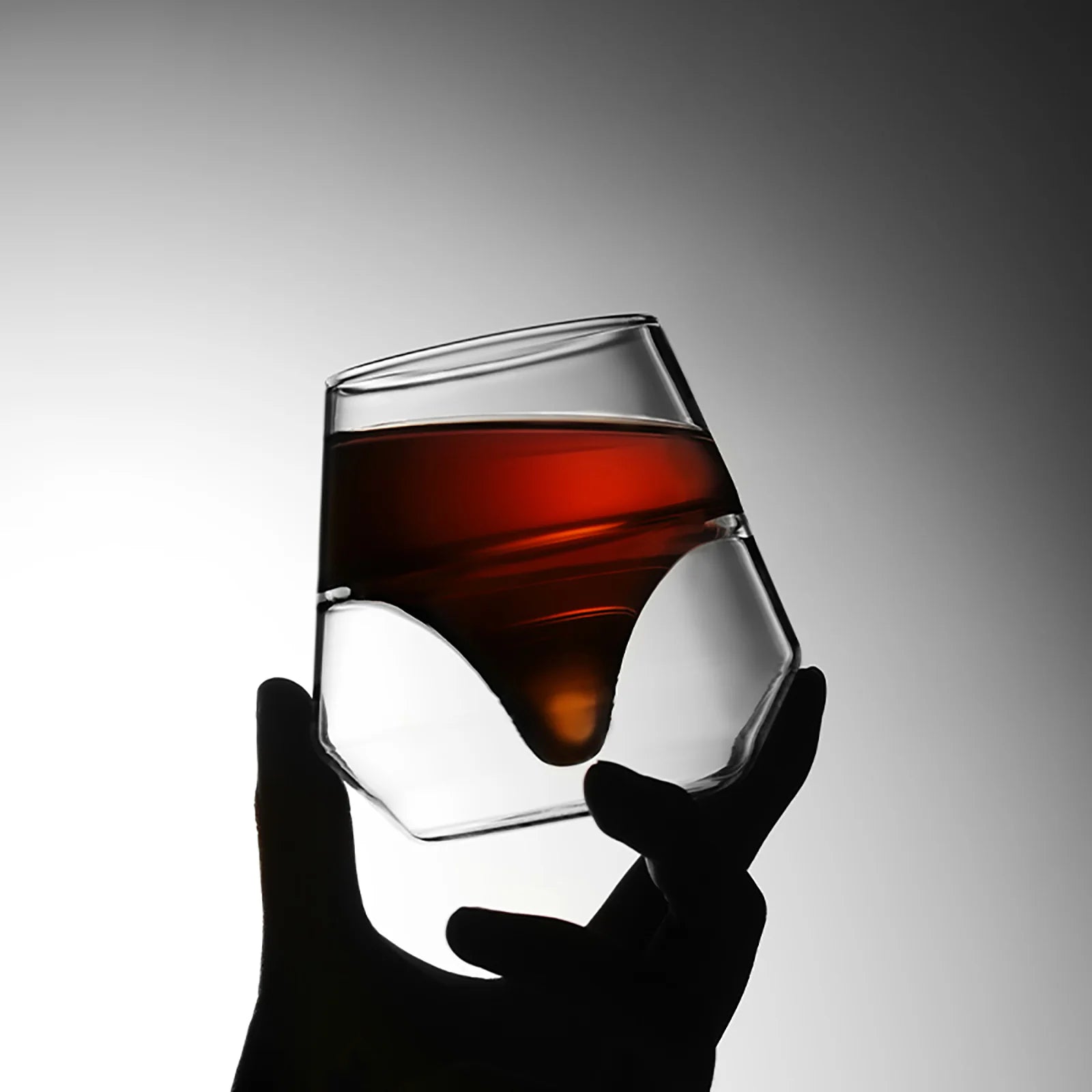 MHW-3BOMBER DW Series glass cup with liquor, double-walled, heat resistant. Held by hand.