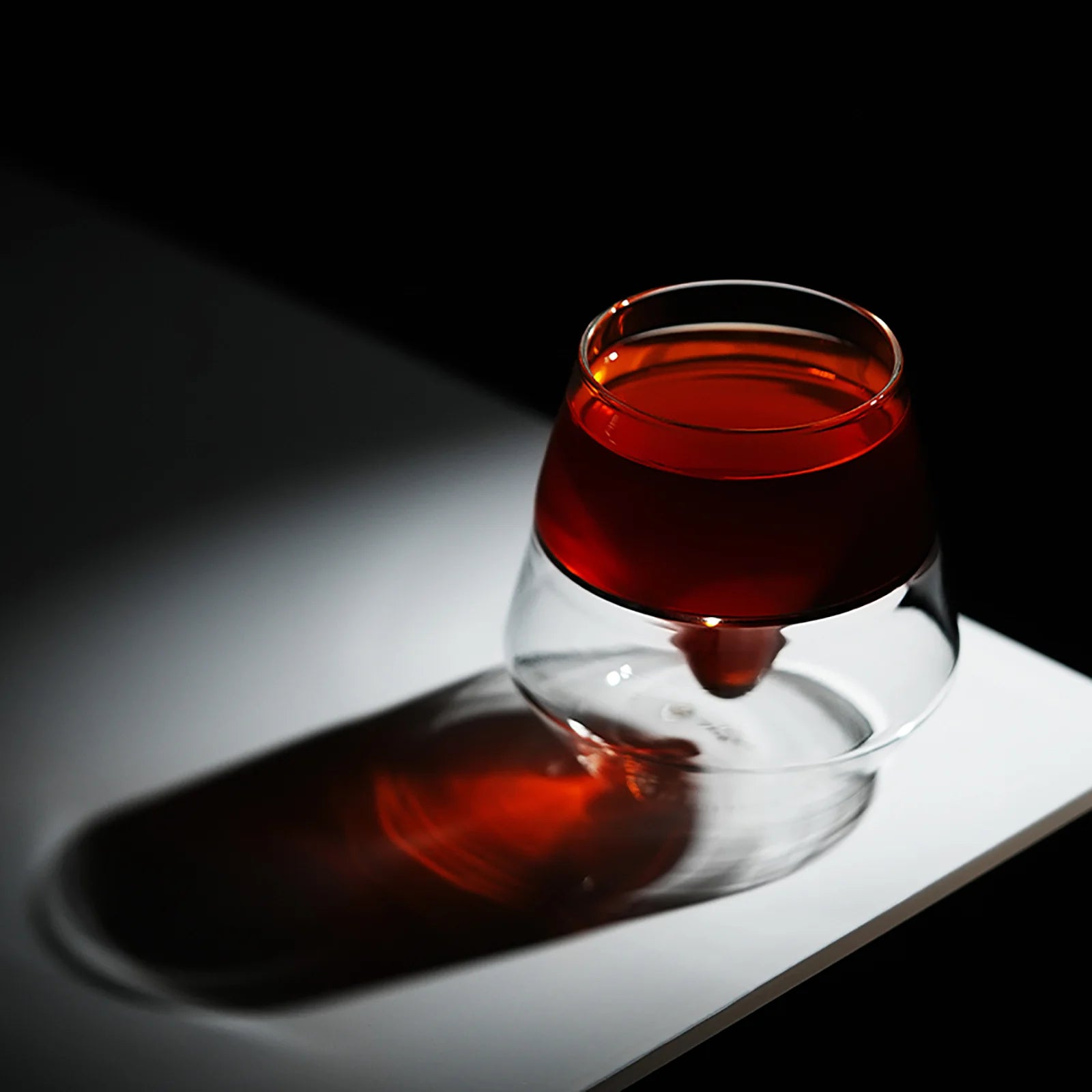 MHW-3BOMBER DW Series Glass Cup with tea. Double-walled, heat-resistant. Clear, ergonomic design.