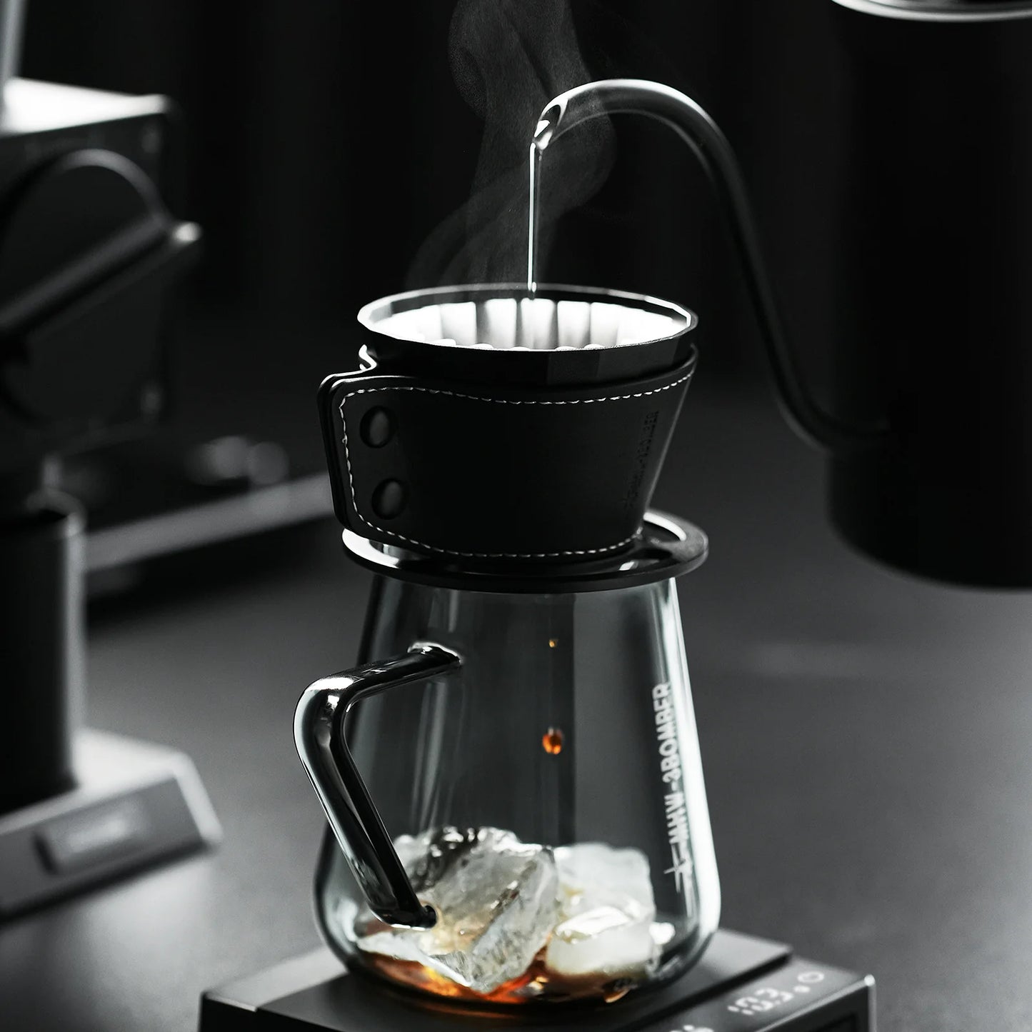 MHW-3BOMBER Meteorite dripper with black holster. Clear glass carafe with ice. Pour over coffee.