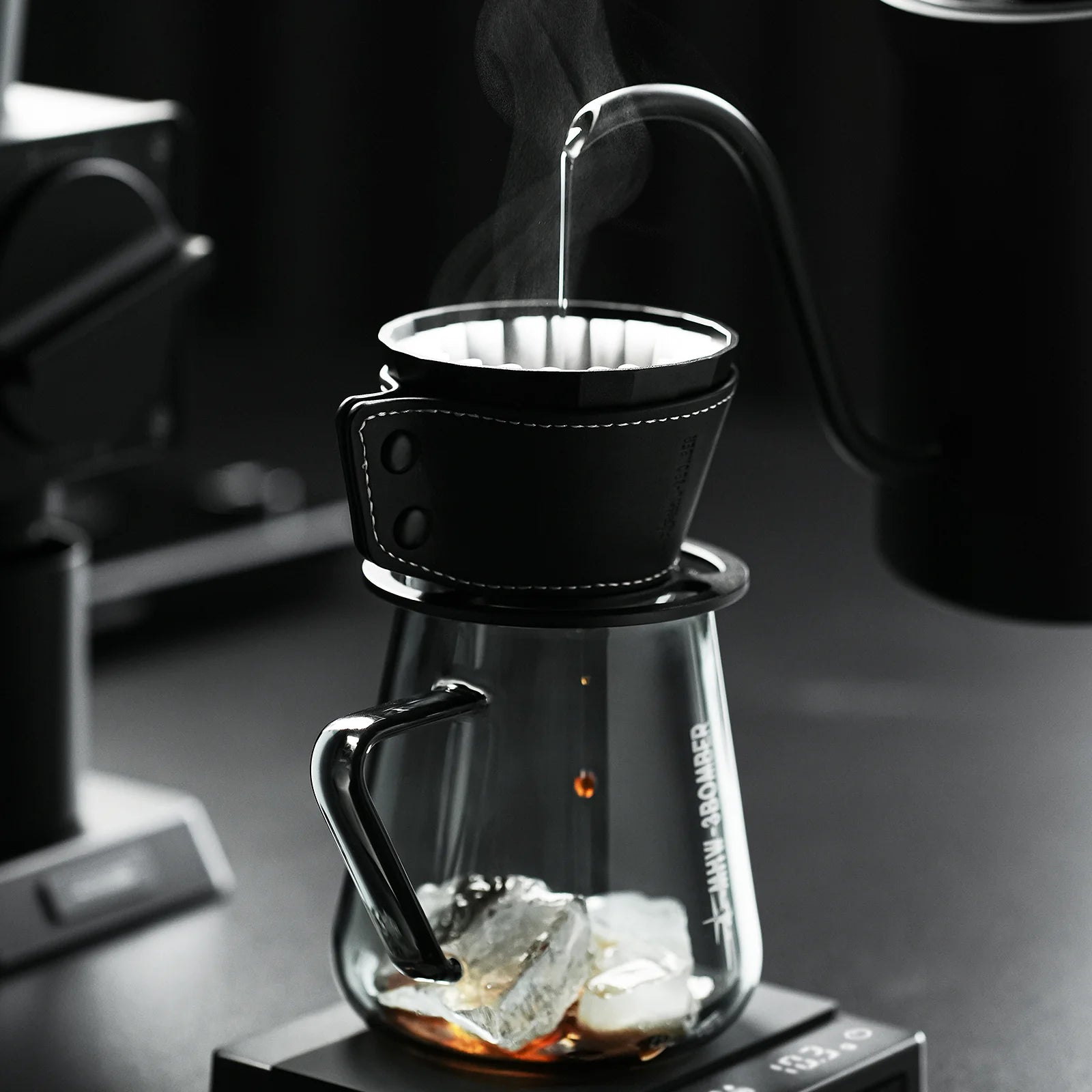 MHW-3BOMBER Meteorite dripper with black holster. Clear glass carafe with ice. Pour over coffee.