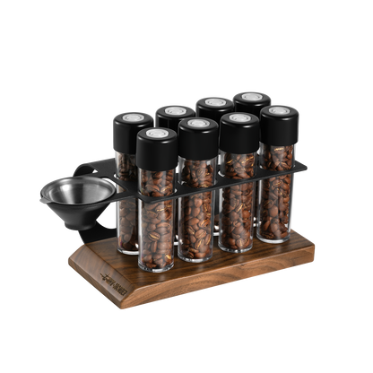 MHW-3BOMBER coffee energy tubes set. Clear tubes with black lids in a wooden and metal stand. Holds coffee beans.